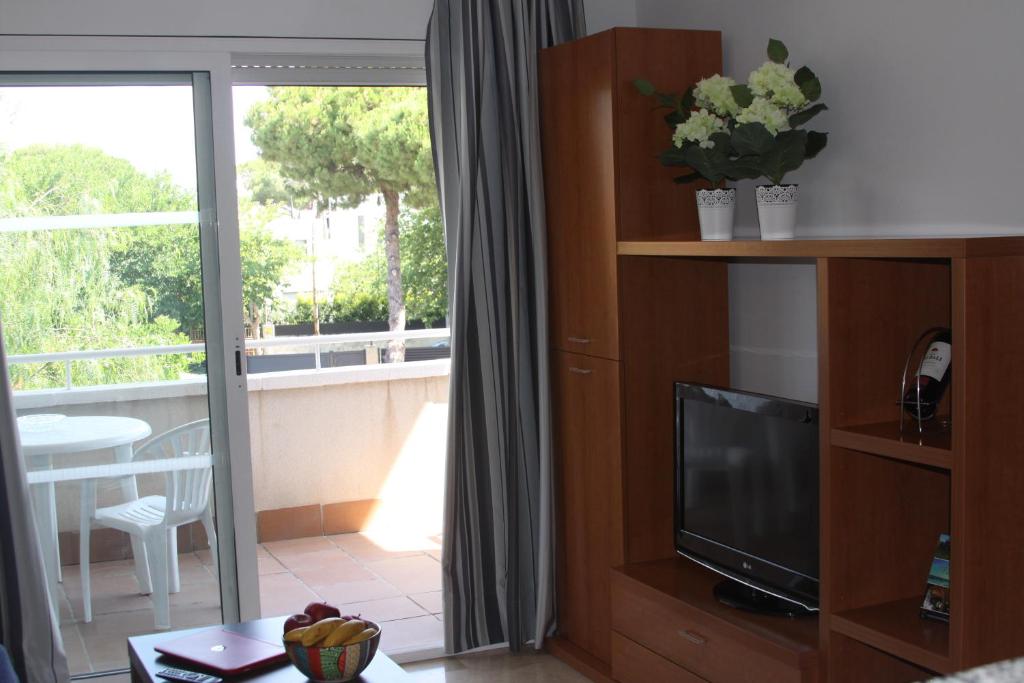 Televízia a/alebo spoločenská miestnosť v ubytovaní Aparthotel Marsol