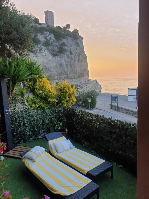 two beds sitting on the grass near the beach at SEAHORSEROOM in Finale Ligure