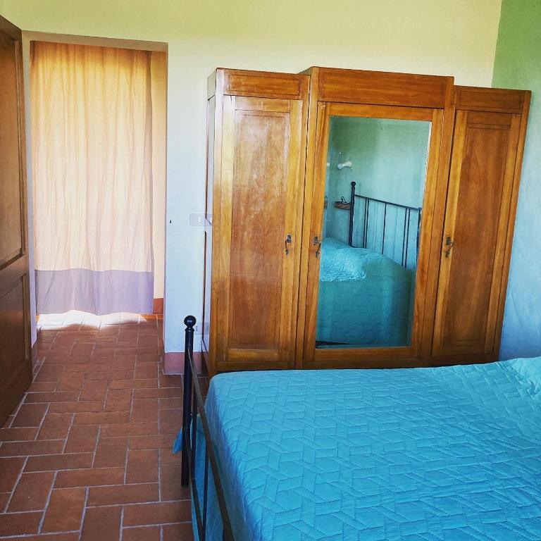 Postel nebo postele na pokoji v ubytování Agriturismo Le Tre Pietre - Podere nel Chianti