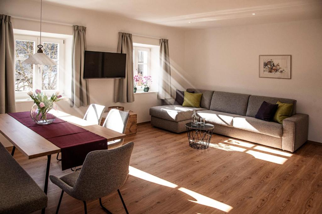 ein Wohnzimmer mit einem Sofa und einem Tisch in der Unterkunft Puenlandhof in Bruneck