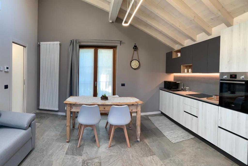 a kitchen and dining room with a table and chairs at Il Fienile - Molino Maufet Mühle - Lake View Terrace in Colico