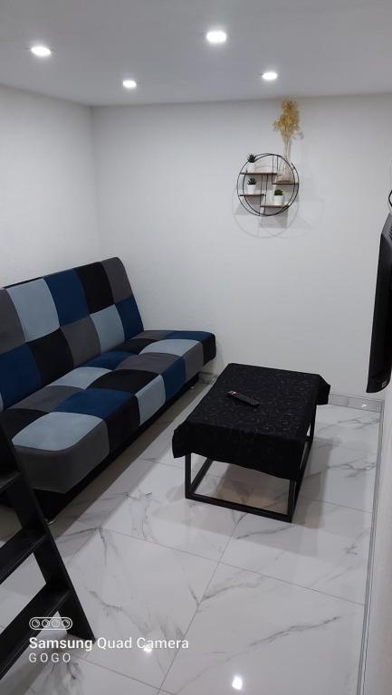 a living room with a couch and a coffee table at Studio Apartman Malkoc in Bihać