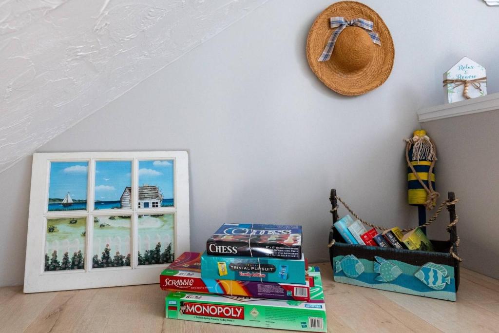 a stack of books in a room with a window at Odysea in Hampton