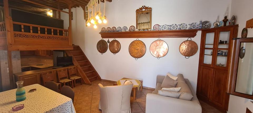 a living room with a couch and a table at Traditional House in Skiros