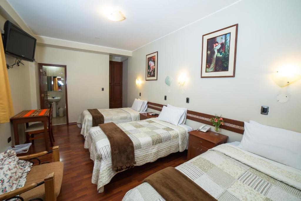 Postel nebo postele na pokoji v ubytování Antawasi Hotel