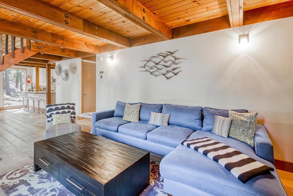 uma sala de estar com um sofá azul e uma mesa em Hammock Holidays em Truckee