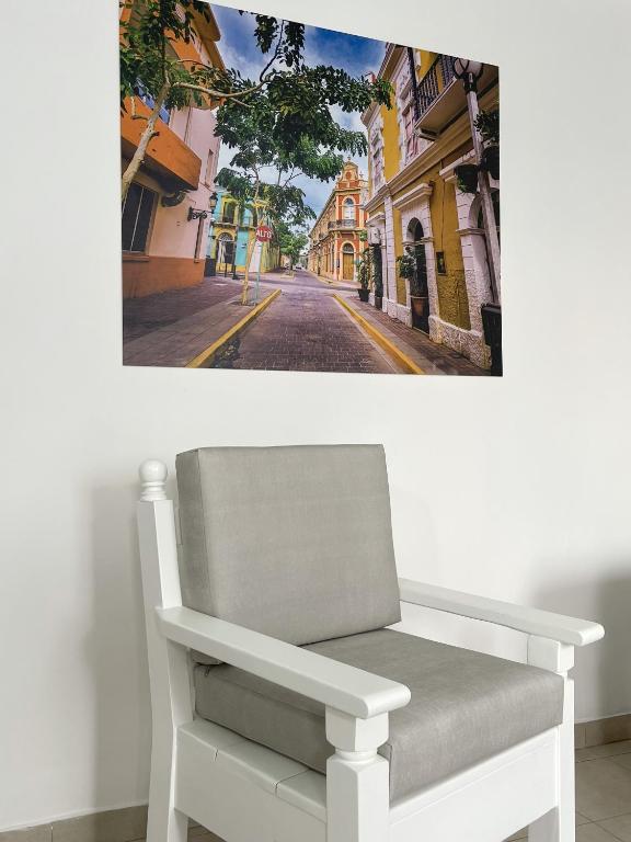 une chaise blanche assise sur le côté de la rue dans l'établissement AZUL ARENA Hotel Boutique, à Mazatlán