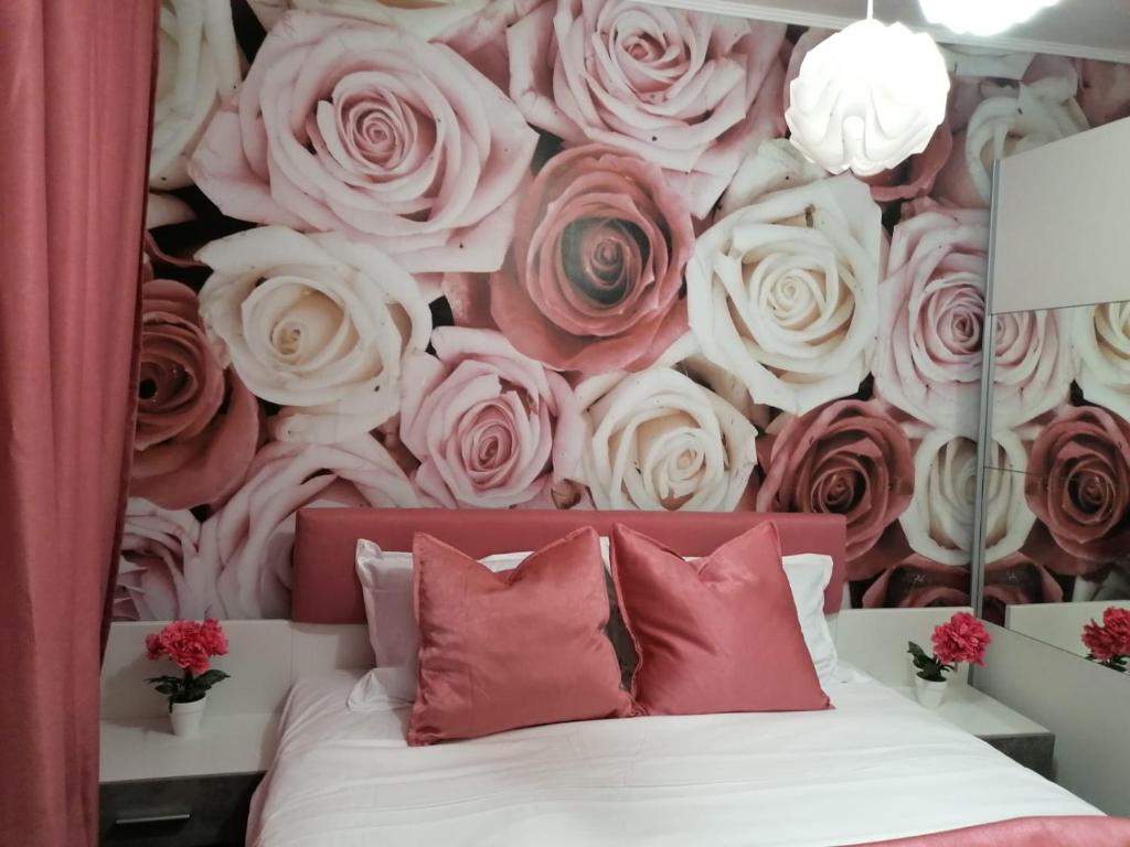 a bedroom with a mural of roses at Dorian Apart in Constanţa