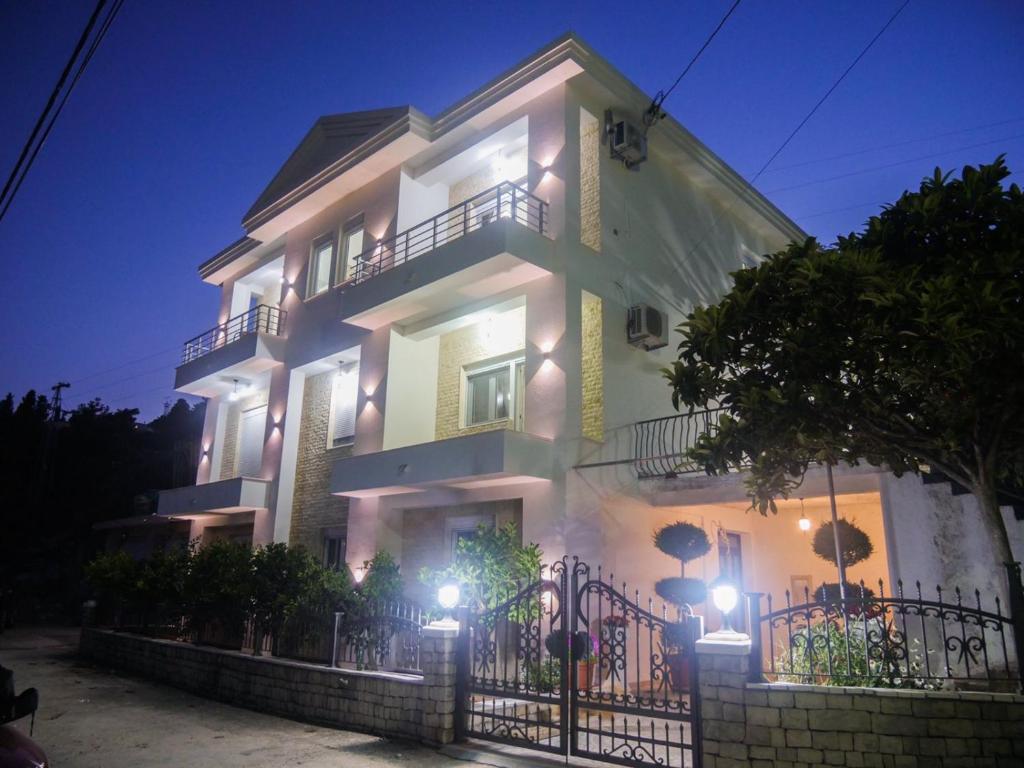 a large white building with lights on it at night at Imperator Apartments in Ulcinj