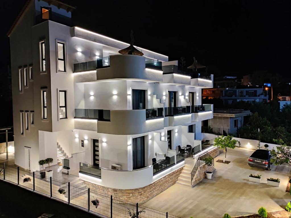 a large white building with lights on it at night at Villa Primo Opus in Ksamil