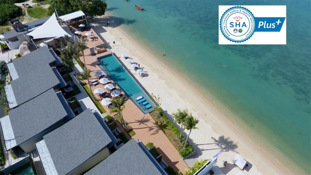 an overhead view of a beach with a resort at Prana Resort Nandana in Bang Rak Beach