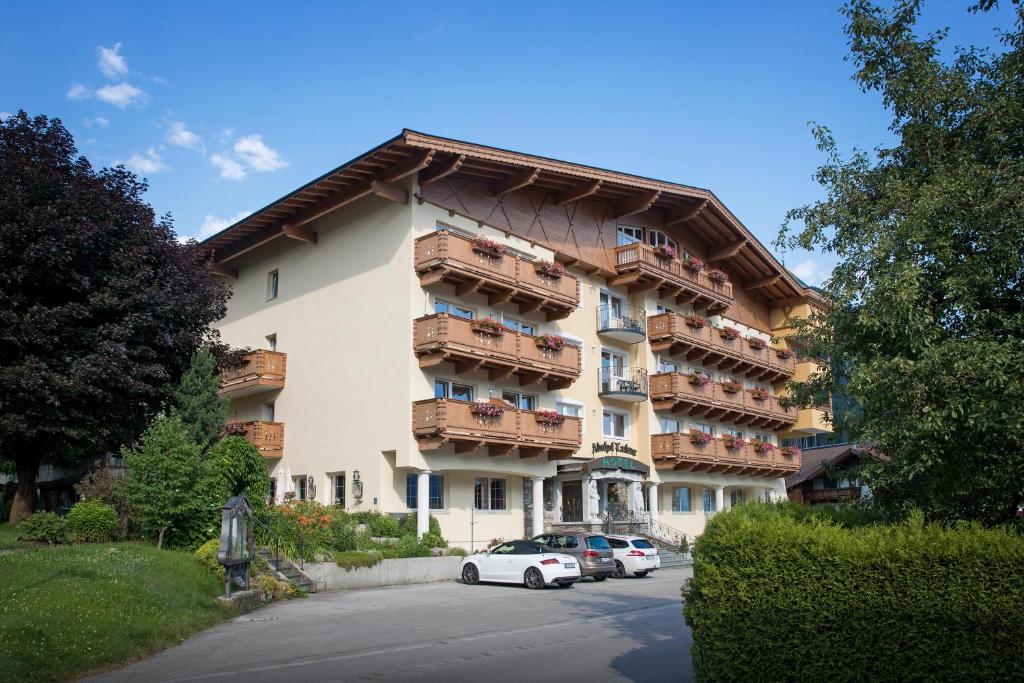 a large apartment building with cars parked in front of it at Almhof Lackner in Ried im Zillertal