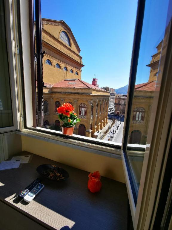 a window with a view of a building at La Dimora del Massimo in Palermo