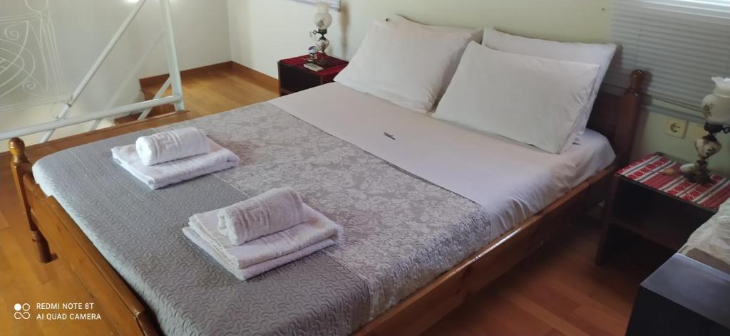 a bed with two towels on top of it at Cozy House in Samoutani in Vrachati