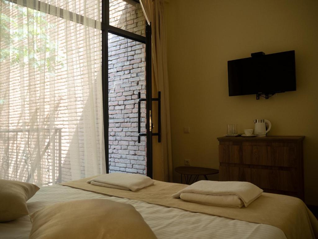 Postel nebo postele na pokoji v ubytování Boutique Hotel Filosofia