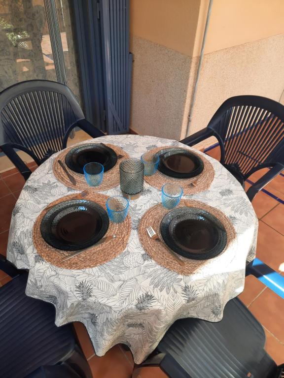 a table with a table cloth with glasses on it at Apartamento Peonia 1 in Canet de Berenguer