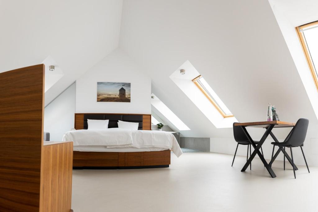 a bedroom with a bed and a table and chairs at Zabjak5 in Ljubljana