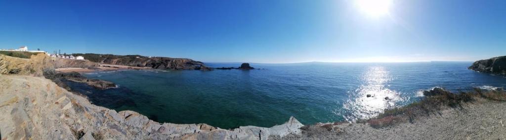 an aerial view of a beach with rocks and the ocean at CASA DA LAGINHA in Zambujeira do Mar