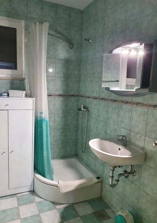 łazienka z umywalką, prysznicem i toaletą w obiekcie Apartmani Huljić w mieście Stari Grad