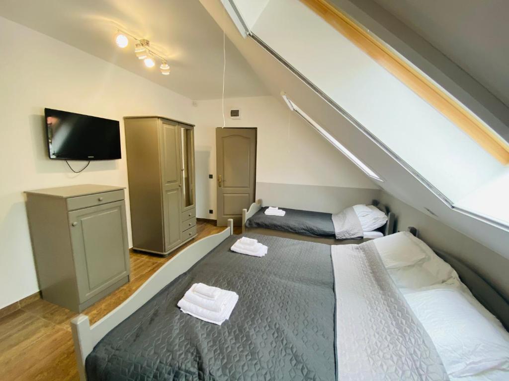 Postel nebo postele na pokoji v ubytování Linton Apartmanház