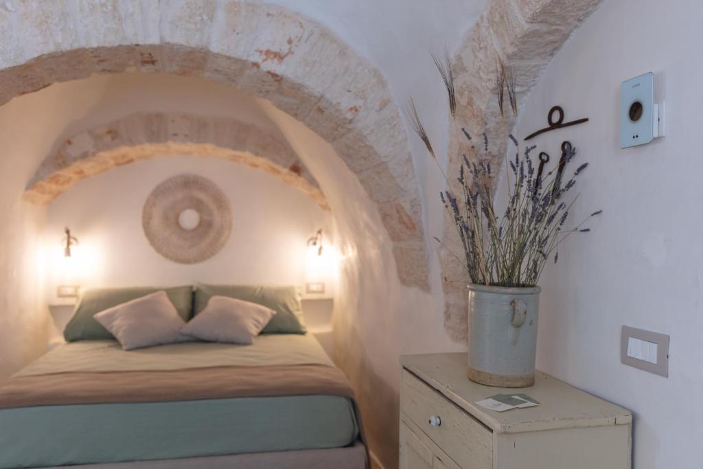 Postel nebo postele na pokoji v ubytování Trulli Magheia