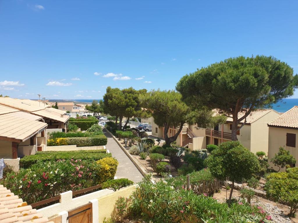 a view of a street in a residential neighborhood with trees and bushes at horizon sur mer 1137 in Saint Pierre La Mer