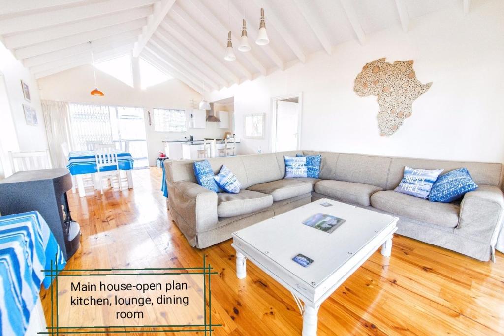 a living room with a couch and a table at Casa Surf Lodge J'Bay in Jeffreys Bay