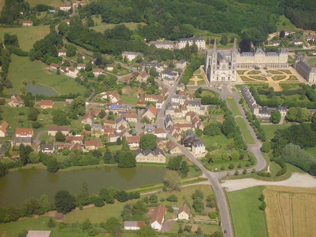 an aerial view of a small town with a castle at Maison dans le bourg in La Chapelle-Montligeon