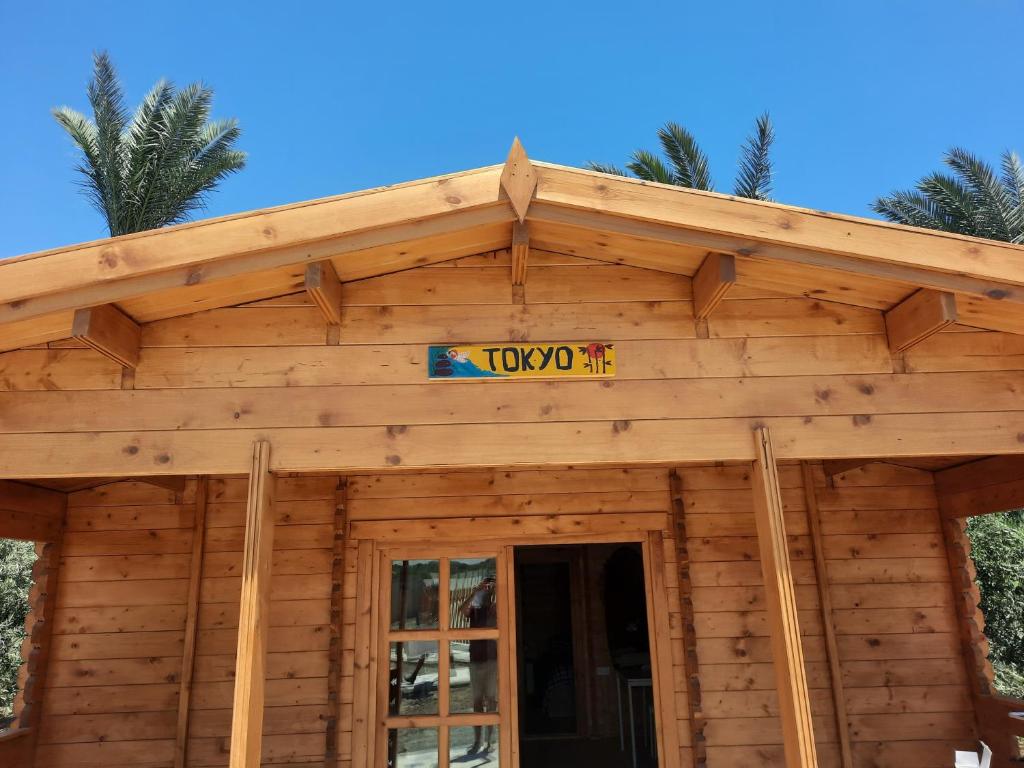 a log cabin with a sign on the roof at Cyprus Glamping Park in Ayios Theodhoros