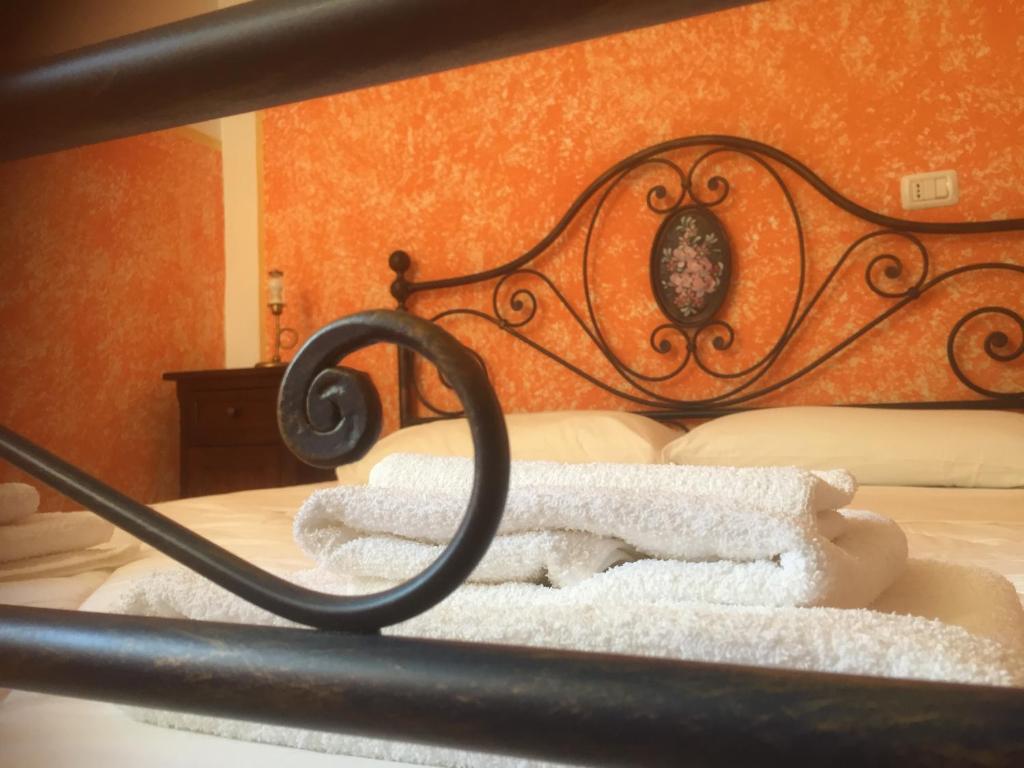a bed with white towels on top of it at La Filanda in Montalto delle Marche