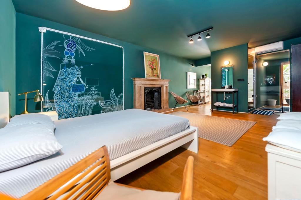a bedroom with a large bed and a fireplace at Apartments & Rooms Carera 6 in Rovinj