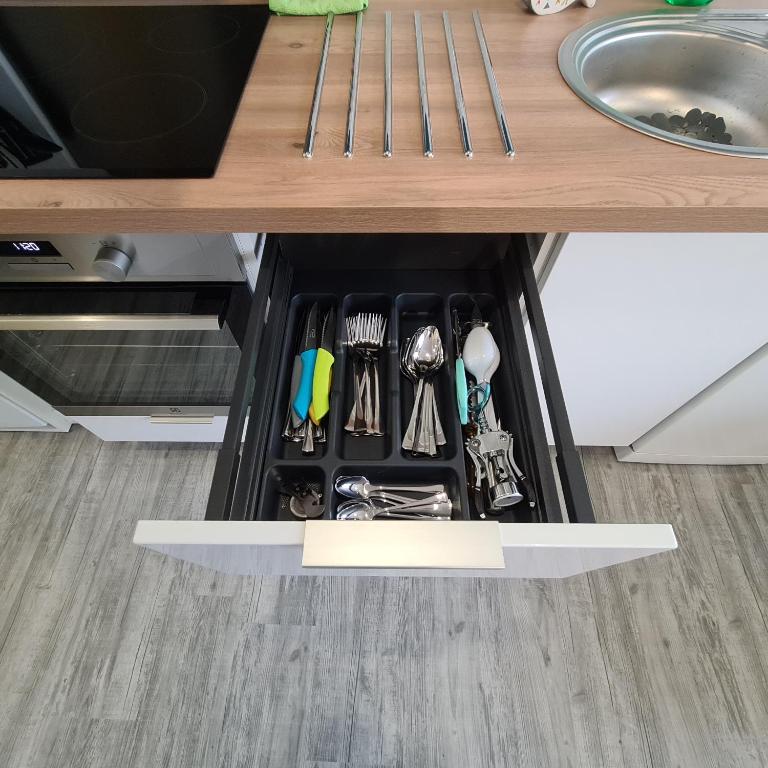 a drawer under a counter with utensils in it at T2 GUYNEMER RDC WIFI Plage à 80m Linge de lit fourni in Les Sables-d&#39;Olonne