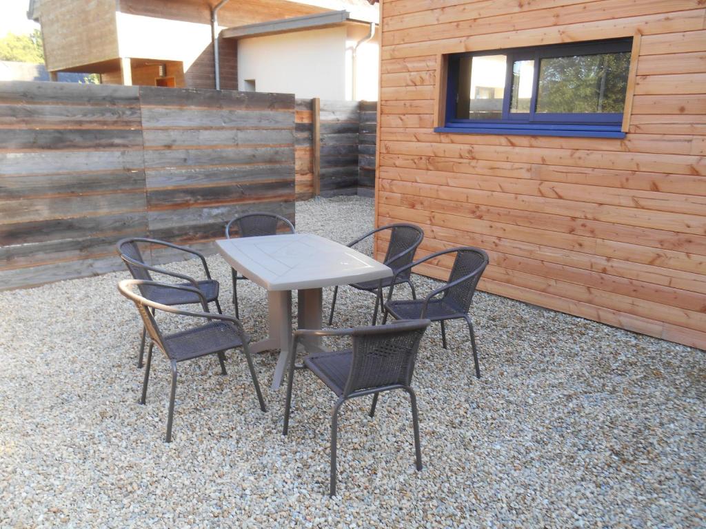 a table and four chairs on a patio at MAISON D'AELA in Assérac