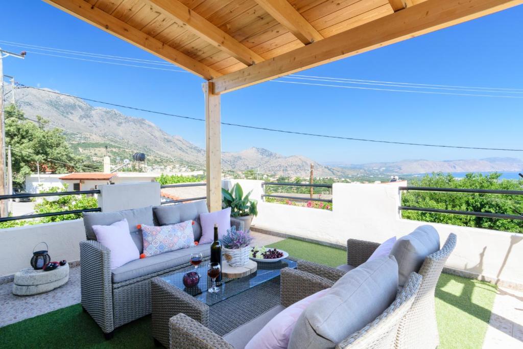 a patio with couches and a table with a view at Casa Vasilia Traditional Home in Kástellos