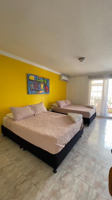 Postel nebo postele na pokoji v ubytování Hotel Balcones de Bocagrande