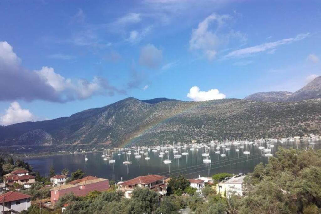 a bunch of boats docked in a lake with a rainbow at Thea family apartments 3 in Yenion