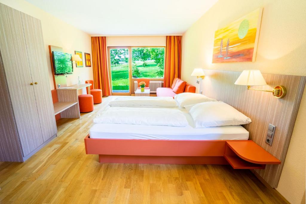 a hotel room with two beds and a bathroom at Wohlfühlhotel Sonnengarten in Überlingen