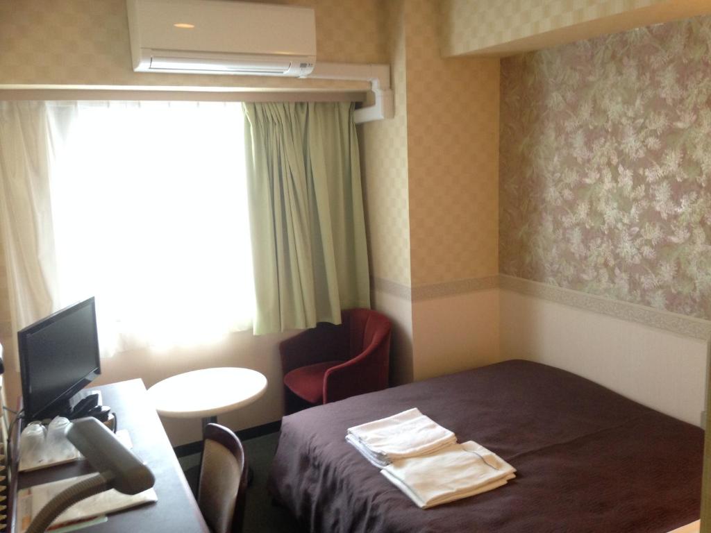 Postel nebo postele na pokoji v ubytování Hotel Select Inn Nagano