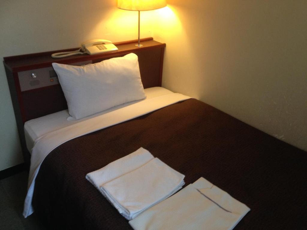 Postel nebo postele na pokoji v ubytování Hotel Select Inn Nagano