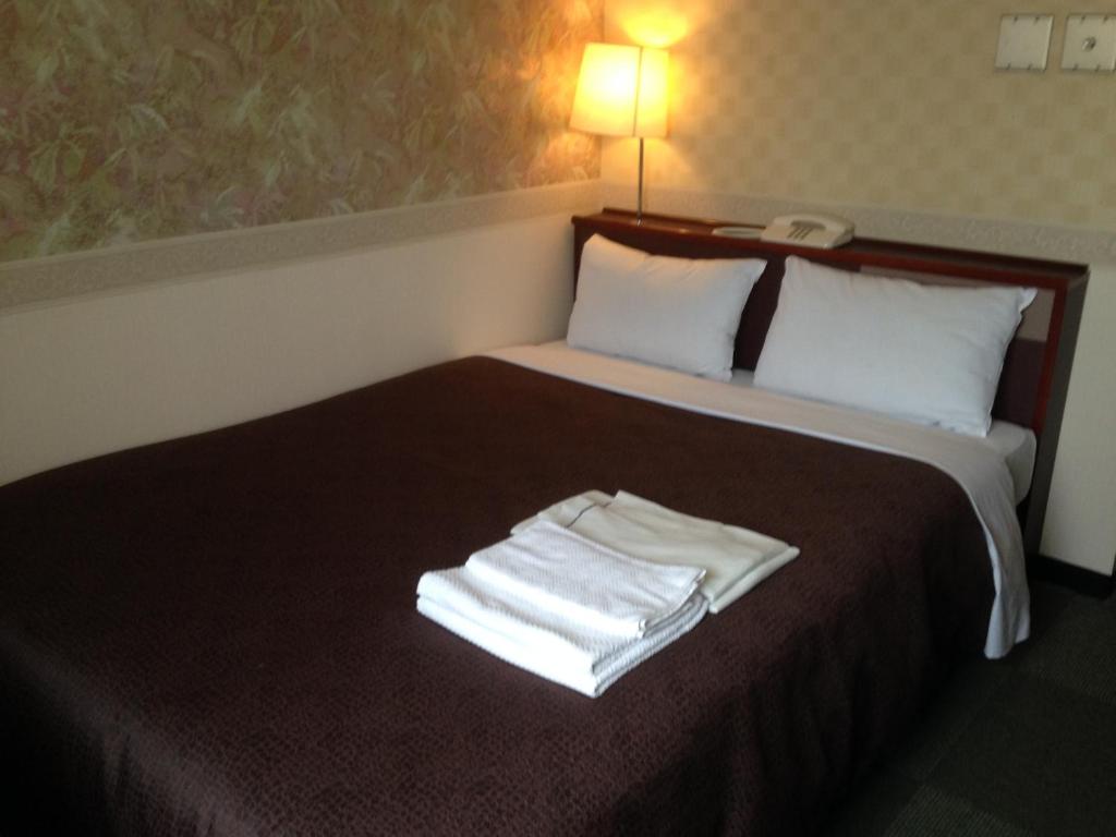 Postel nebo postele na pokoji v ubytování Hotel Select Inn Nagano