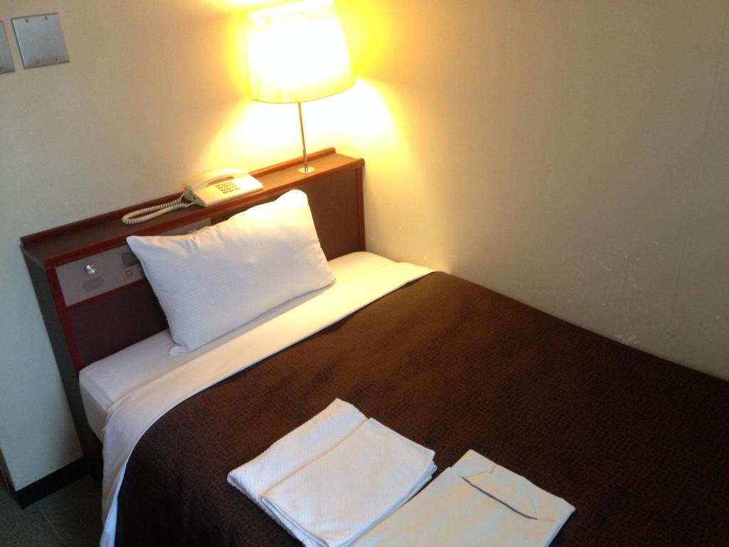 Postel nebo postele na pokoji v ubytování Hotel Select Inn Nagano