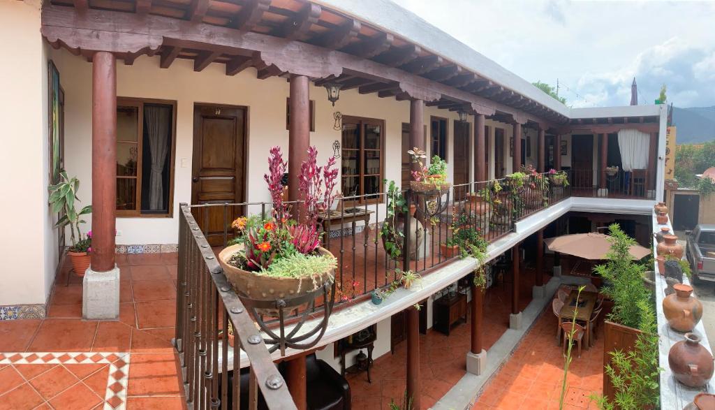 a balcony of a house with potted plants on it at Hotel Mansion Del Rey in Antigua Guatemala