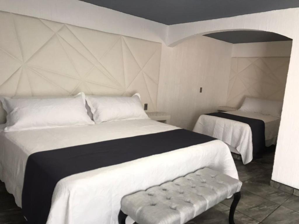 Postel nebo postele na pokoji v ubytování Hotel Nuevo Bernal