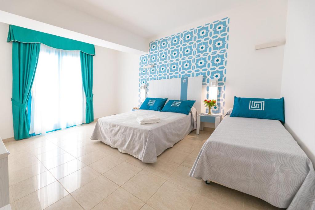 Postel nebo postele na pokoji v ubytování Hotel Magna Grecia