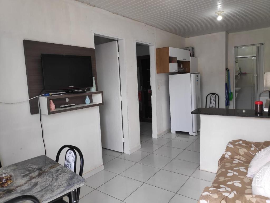 a living room with a tv and a couch and a table at ApartofFerdi in São Luís