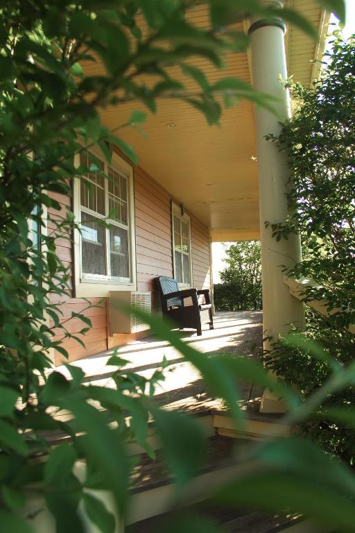 a porch of a house with a chair on it at Silverwood Motel in Cavendish