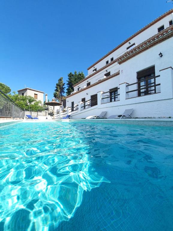 a pool of water in front of a building at La Luna del sur B&B in Granada