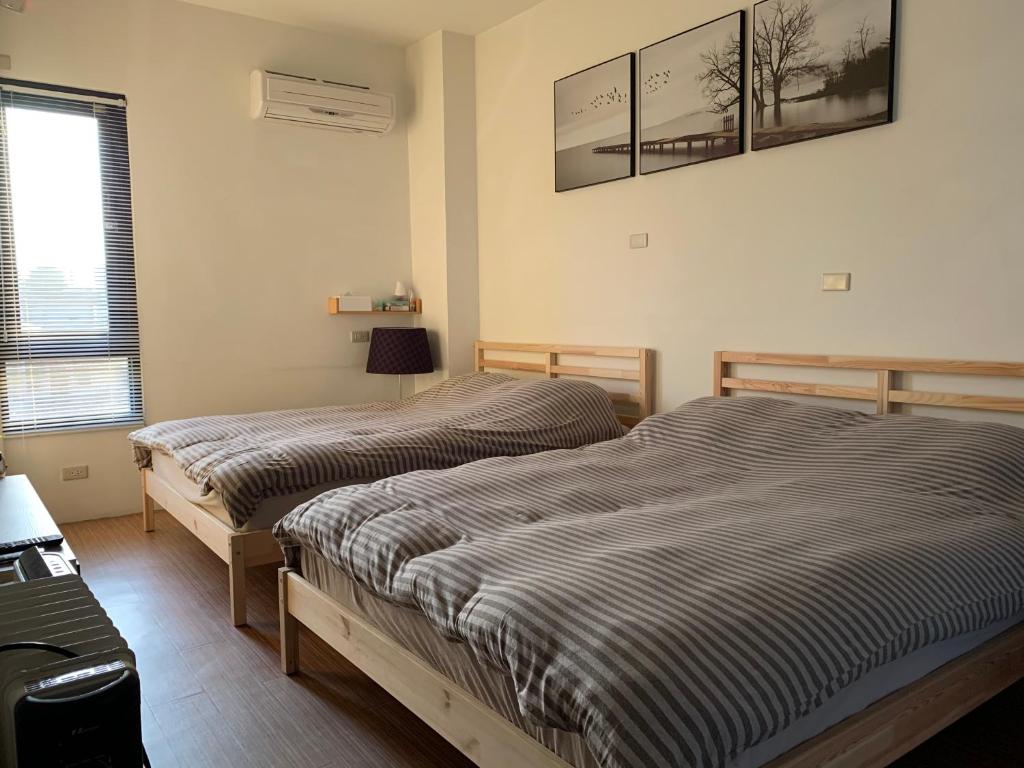 Postel nebo postele na pokoji v ubytování 幸福客棧