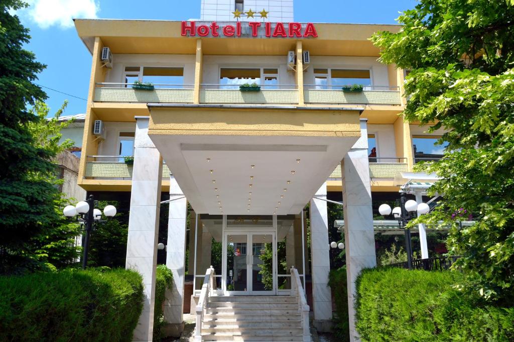 a hotel with a sign on the front of it at Hotel Tiara in Ploieşti