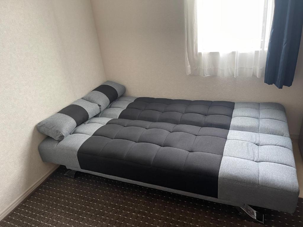 a large bed in a room with a window at Bessalov Home 1st room friendly house in Tokyo